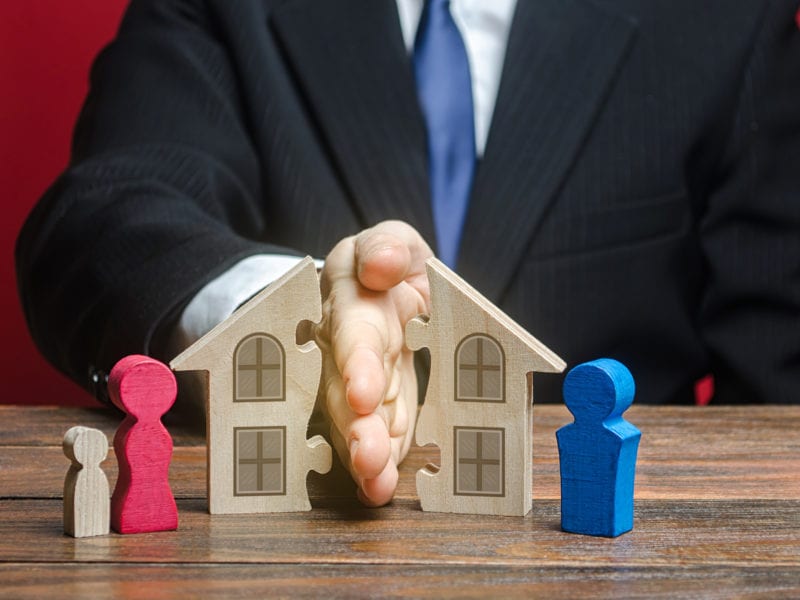 Man shares a house between former spouses in a divorce process. Disputes over fair division of marital property real estate. Protection of rights. Conflict resolution. Court, justice. Lawyer services