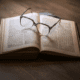 A book of law opened with a pair of glasses on top.