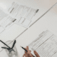 A Pen In Someone’s Hand Poised Over An Adoption Application